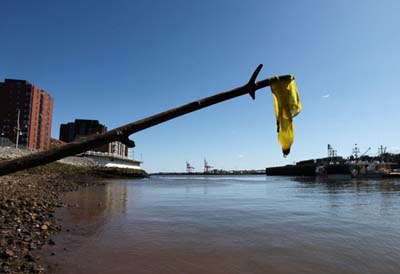 A condom is seen hanging from a stick the photographer is holding that came from the sewage outfall pipe in the Saint John harbour Thursday May 13, 2010. (ANDRE FORGET/QMI AGENCY)